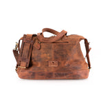 The Leather Duffle Bag Tokyo by Vintage Leather Sydney features brown leather, a shoulder strap, top handles, a front zip pocket, and a small embossed logo on the front, shown against a white background.