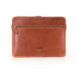 The Leather Laptop Sleeve Signature by Vintage Leather Sydney is a brown leather zippered sleeve with a front pocket, gold zipper, and embossed logo, shown against a white background.