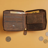 The Discover the Ultimate Mens Zipper Wallet - Urban by Vintage Leather Sydney, made from full-grain leather, is open on a light brown surface with cash and coins inside, surrounded by scattered coins.