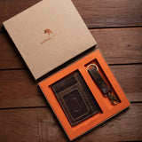 The Leather Gift Box With Credit Card Wallet & Keyring by Vintage Leather Sydney is displayed on a wooden surface in an orange and brown leather box.