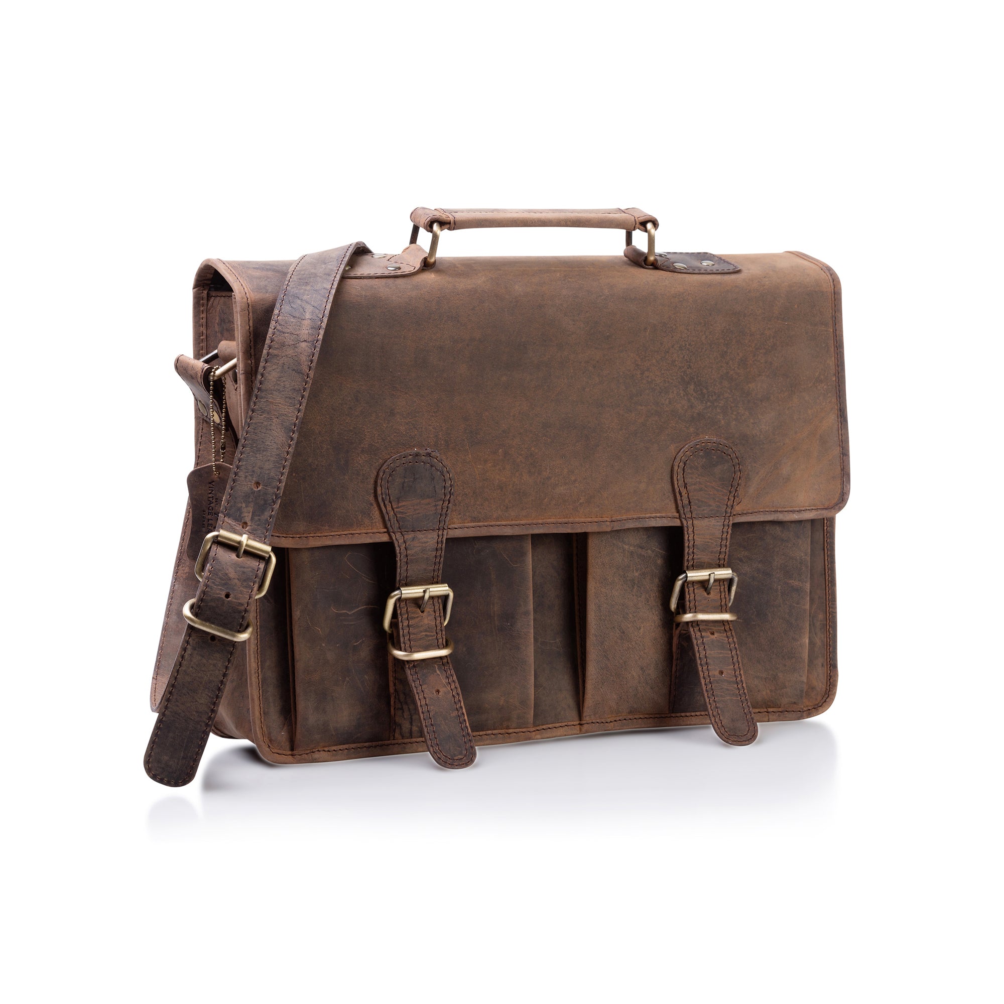 The Vintage Leather Messenger Bag - Melbourne is a brown full-grain leather satchel with a top handle, adjustable shoulder strap, front buckled pockets, and a spacious laptop compartment, shown against a white background.
