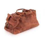 The Leather Duffle Bag Berlin by Vintage Leather Sydney, featuring brown leather, multiple handles, brass hardware, and a zippered side pocket, is shown on a white background—ideal for a stylish and functional travel companion.