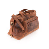 The Leather Duffle Bag Tokyo by Vintage Leather Sydney features brown leather, two handles, a zipper closure, an adjustable shoulder strap, and a front zip pocket, shown on a white background.