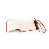 The Vintage Leather Sydney Leather Photo Book Memo features blank pages and a classic leather strap, lying open on a white surface—ideal for stylishly jotting thoughts or organizing notes.