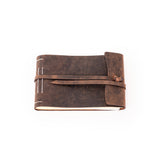 The Leather Photo Book Memo by Vintage Leather Sydney is a brown, leather-bound journal with a wraparound strap closure and visible white stitching, shown closed on a plain white background.
