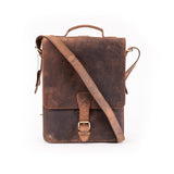 The Ryder Courier Satchel by Vintage Leather Sydney is a brown leather bag with a top handle, adjustable shoulder strap, and buckle-front flap, ideal for everyday use. Displayed on a plain white background.