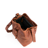 The Rosa Leather Crossbody Bag by Vintage Leather Sydney features brown leather, an adjustable strap, gold-tone hardware, a spacious dark-lined interior with inner pockets, and drawstring accents—adding timeless style to any look.